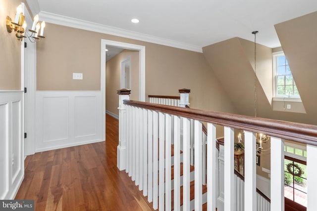 corridor with crown molding, dark hardwood / wood-style floors, and a notable chandelier