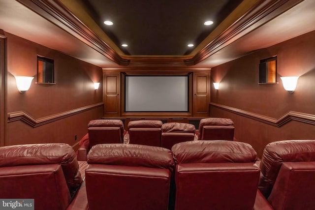 home theater featuring a tray ceiling and crown molding