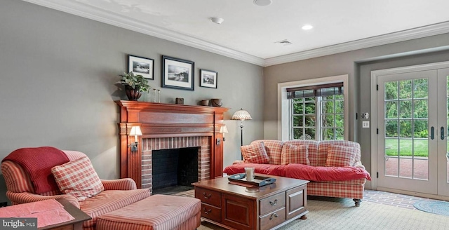 sitting room featuring crown molding, french doors, and a brick fireplace