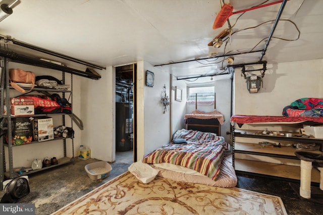 bedroom with water heater and concrete flooring