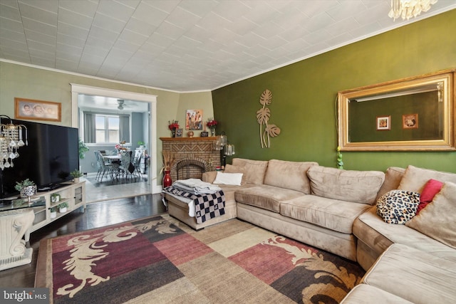 living room featuring a fireplace, hardwood / wood-style floors, and ornamental molding