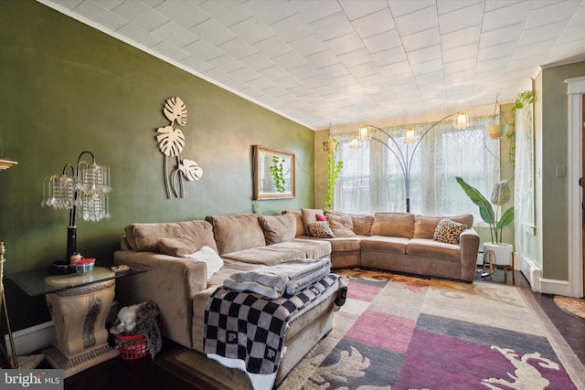 living room with wood-type flooring and ornamental molding