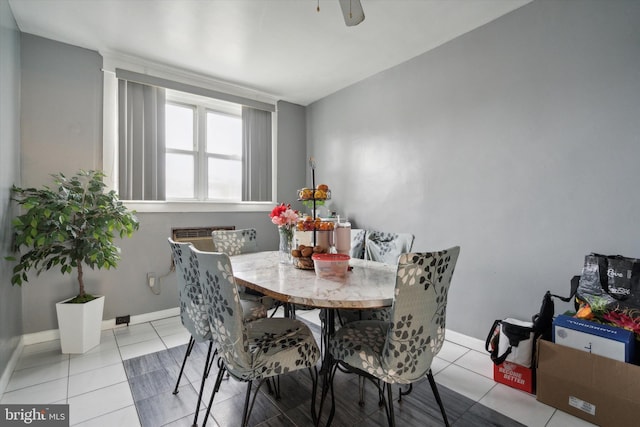 tiled dining area featuring ceiling fan