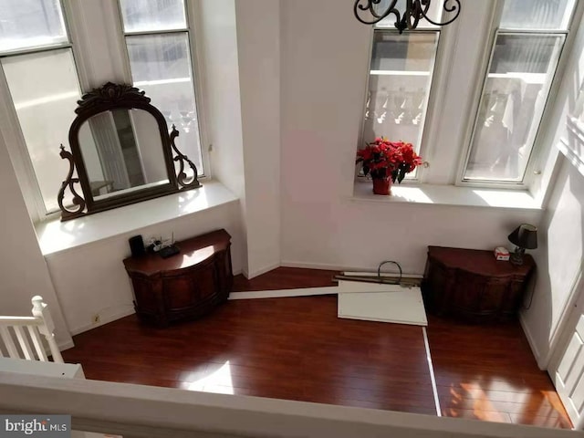 interior space featuring a chandelier and dark wood-type flooring