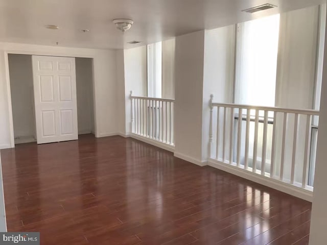 spare room with dark hardwood / wood-style floors