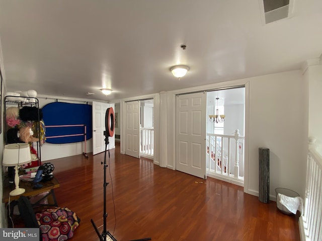 interior space featuring a chandelier and dark wood-type flooring