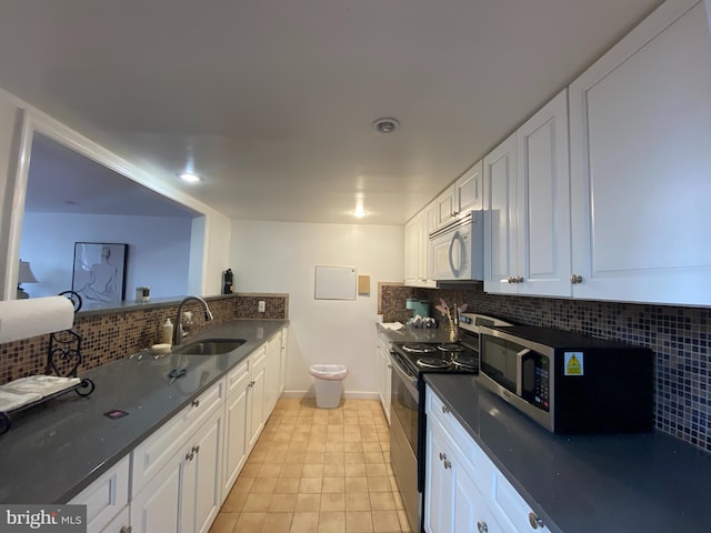 kitchen featuring white cabinets, decorative backsplash, sink, and stainless steel appliances