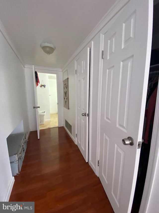 hall with dark hardwood / wood-style flooring and crown molding