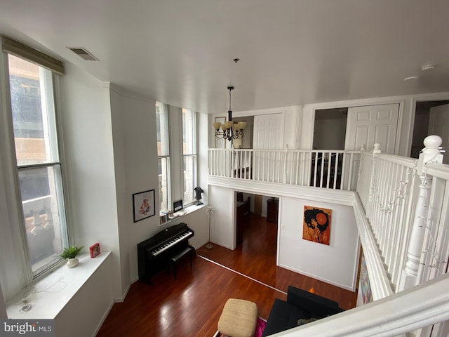 living room featuring dark hardwood / wood-style flooring and an inviting chandelier