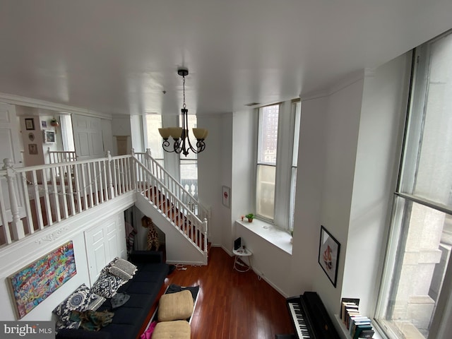 living room with dark hardwood / wood-style flooring and an inviting chandelier