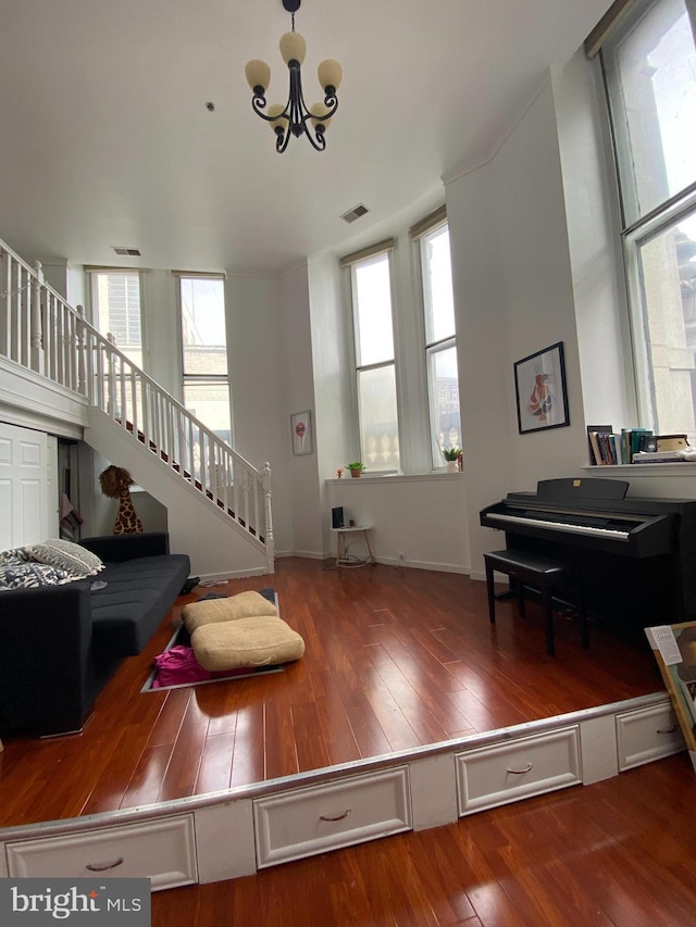 living room featuring wood-type flooring and a chandelier