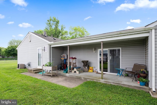 back of house with a patio, central AC, and a lawn