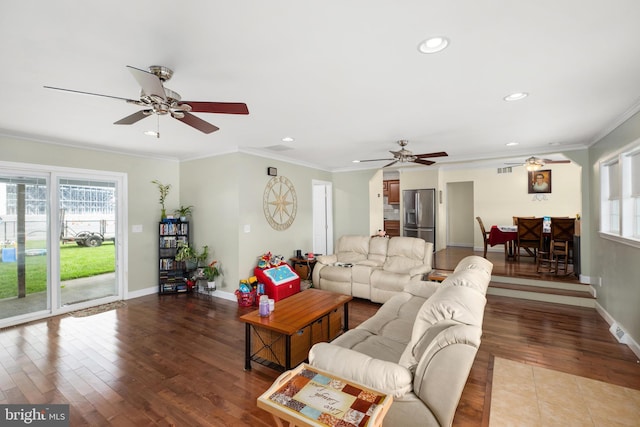 living room featuring wood-type flooring and ornamental molding