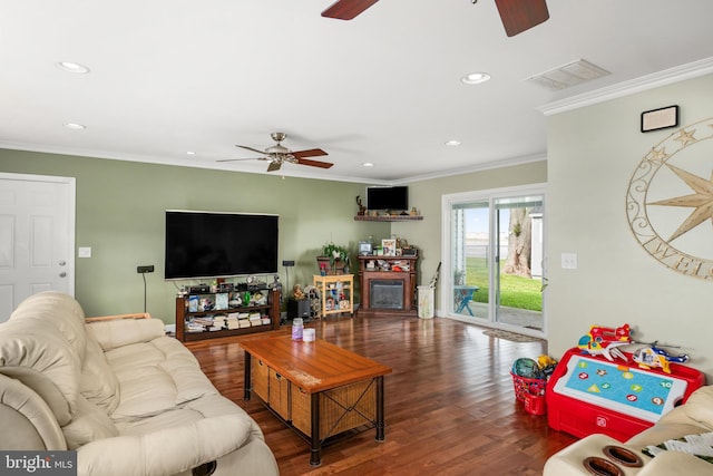 living room featuring dark wood-type flooring and ornamental molding