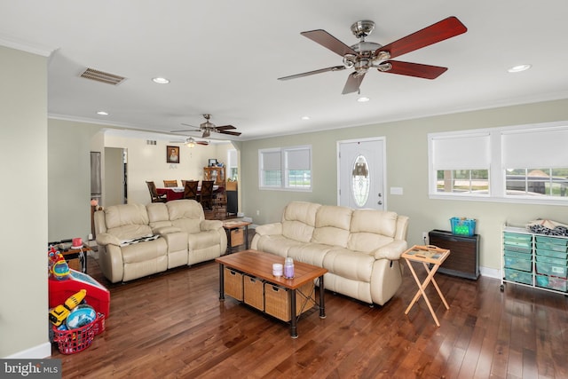 living room featuring dark hardwood / wood-style floors and crown molding