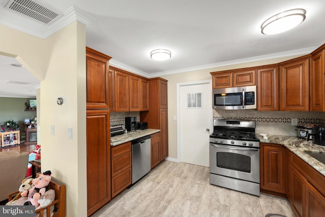 kitchen with light stone countertops, backsplash, stainless steel appliances, and crown molding