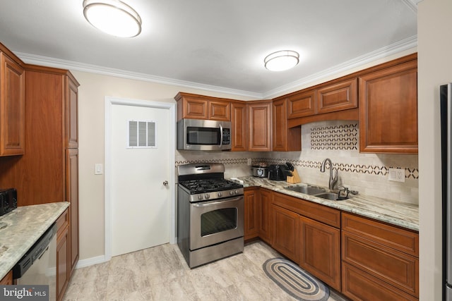 kitchen featuring sink, ornamental molding, appliances with stainless steel finishes, tasteful backsplash, and light stone counters