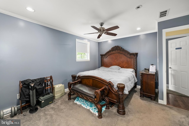 carpeted bedroom featuring ceiling fan and crown molding