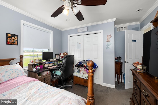 carpeted bedroom with a closet, ceiling fan, and crown molding