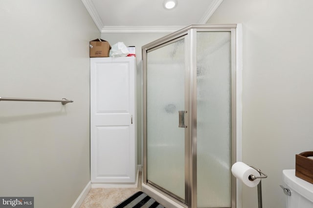 bathroom featuring tile patterned flooring, toilet, a shower with shower door, and ornamental molding