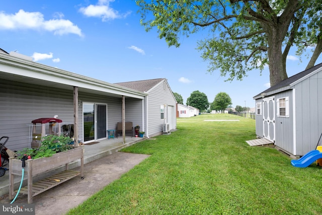 view of yard with a patio area and a shed