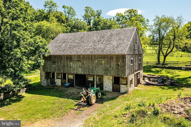 view of outbuilding featuring a yard