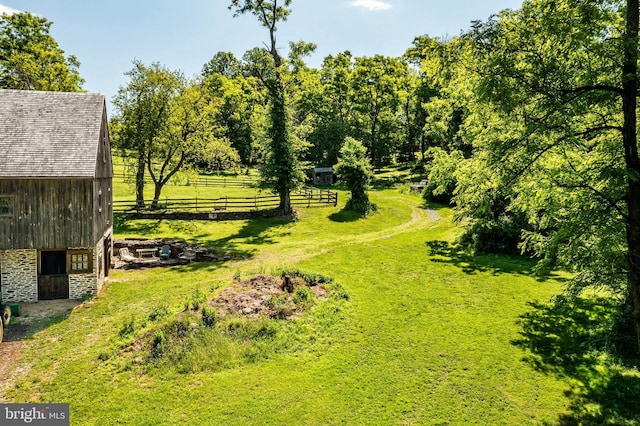 view of yard with a rural view and an outbuilding