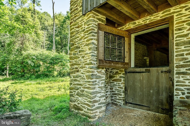 view of side of home featuring an outbuilding