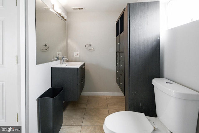 bathroom with tile patterned flooring, vanity, and toilet