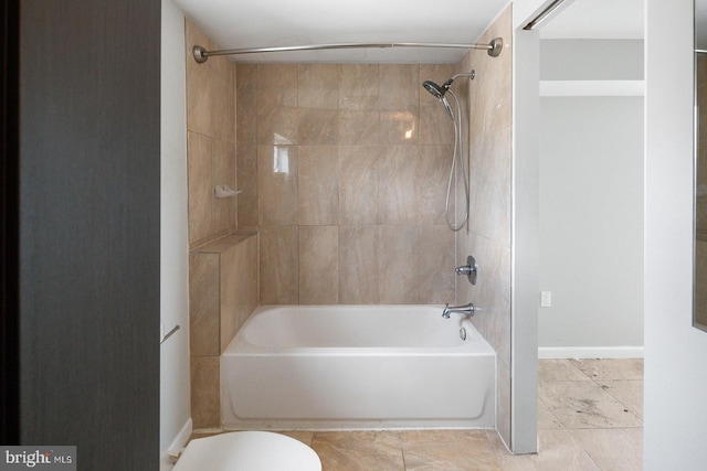 bathroom with tiled shower / bath and toilet