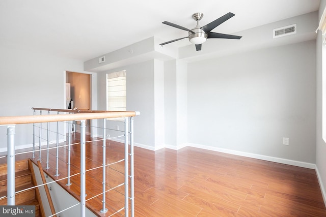 empty room featuring ceiling fan and wood-type flooring