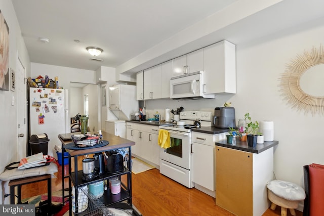 kitchen featuring white cabinetry, light hardwood / wood-style flooring, and white appliances