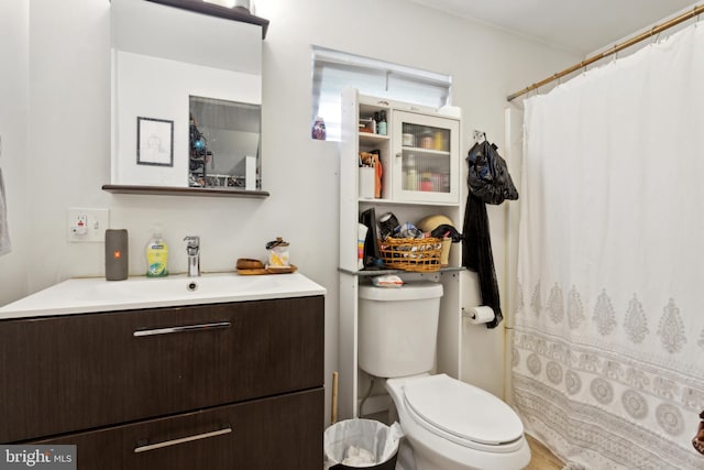 bathroom with hardwood / wood-style floors, vanity, toilet, and a shower with curtain