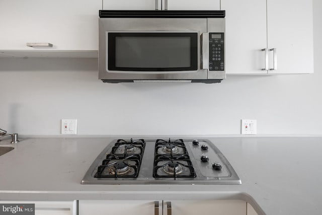 details featuring white cabinetry and gas stovetop