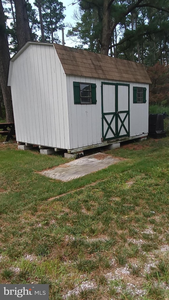 view of outbuilding featuring a lawn