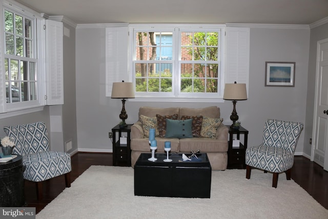 living room featuring a healthy amount of sunlight, dark hardwood / wood-style flooring, and ornamental molding