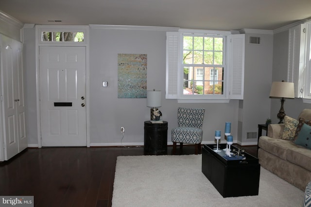 living room featuring dark hardwood / wood-style flooring and crown molding