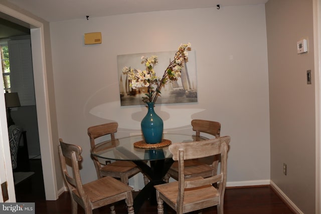 dining area with dark hardwood / wood-style floors