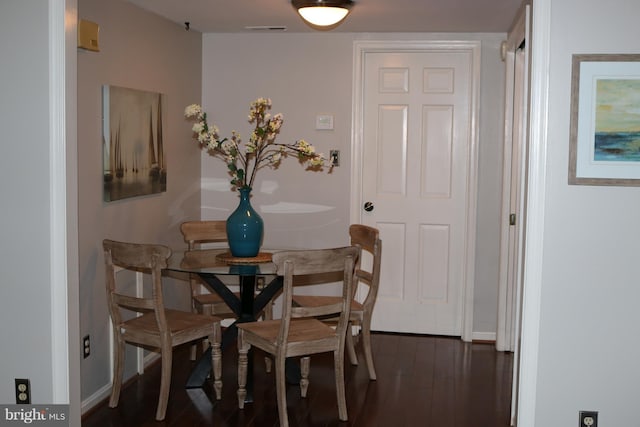 dining area with dark hardwood / wood-style flooring