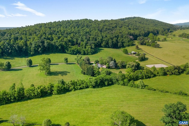 bird's eye view with a mountain view, a view of trees, and a rural view