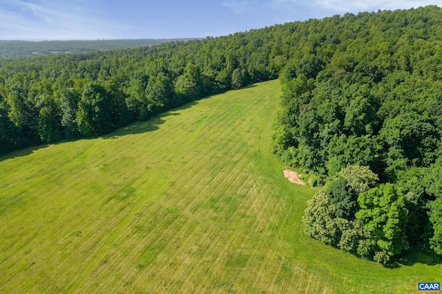 drone / aerial view featuring a forest view