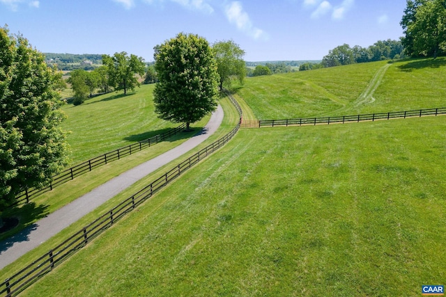 view of yard with a rural view and fence