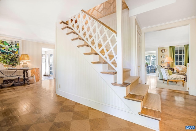 stairs with crown molding and baseboards