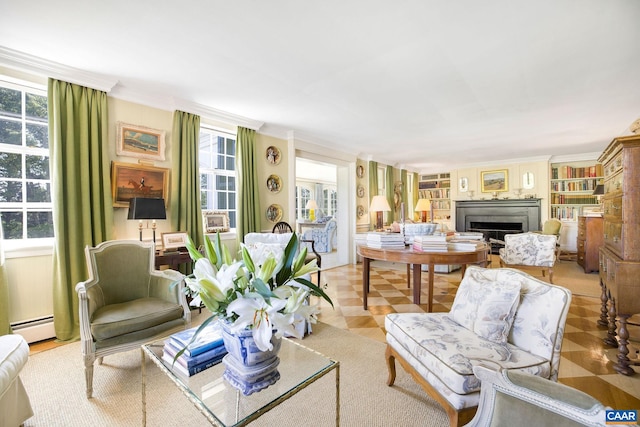 living room with a fireplace, a baseboard heating unit, and crown molding