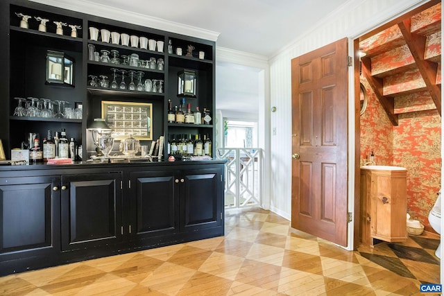 bar with crown molding, a dry bar, and wallpapered walls