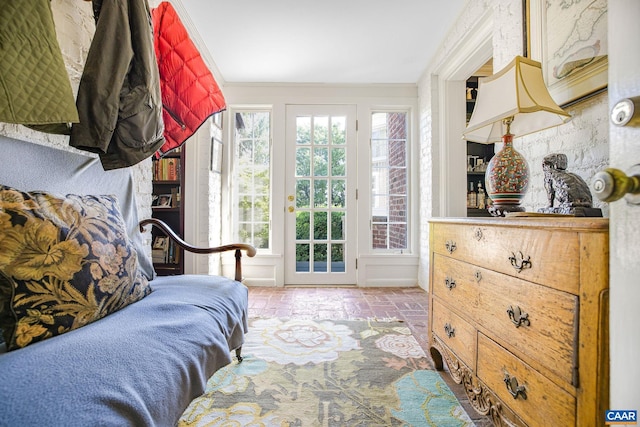 sitting room with brick floor and ornamental molding