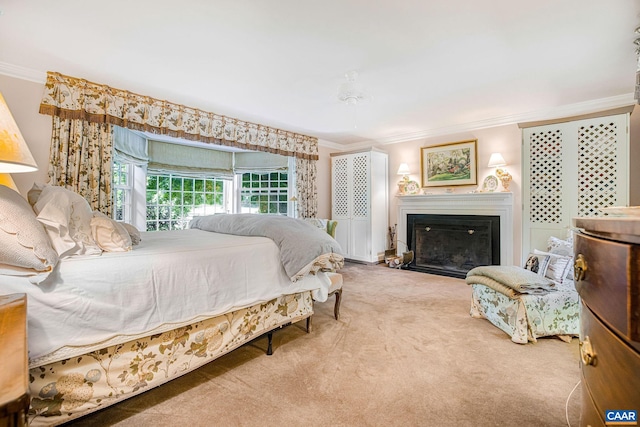 bedroom with a fireplace, crown molding, and carpet flooring