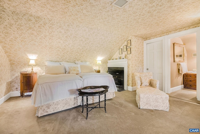 carpeted bedroom featuring wallpapered walls, a fireplace with flush hearth, baseboards, and a closet