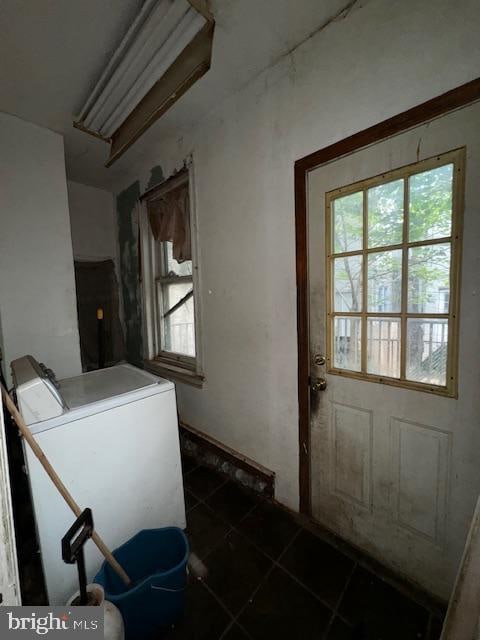 laundry area featuring dark tile patterned floors and washer / clothes dryer