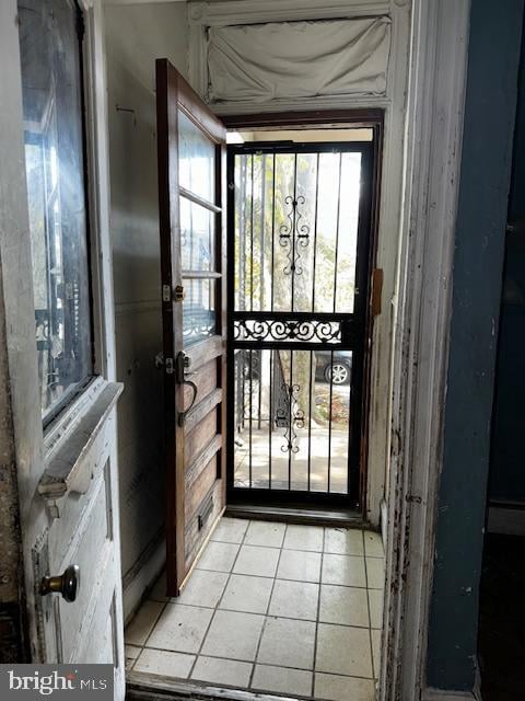 doorway featuring light tile patterned flooring